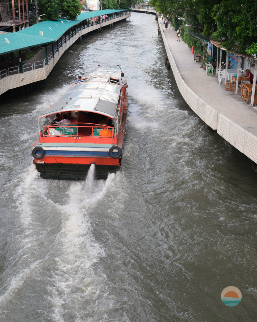 An express boat speeding down the narrow Khlong Saen Saep canal past Ban Khrua, Bangkok