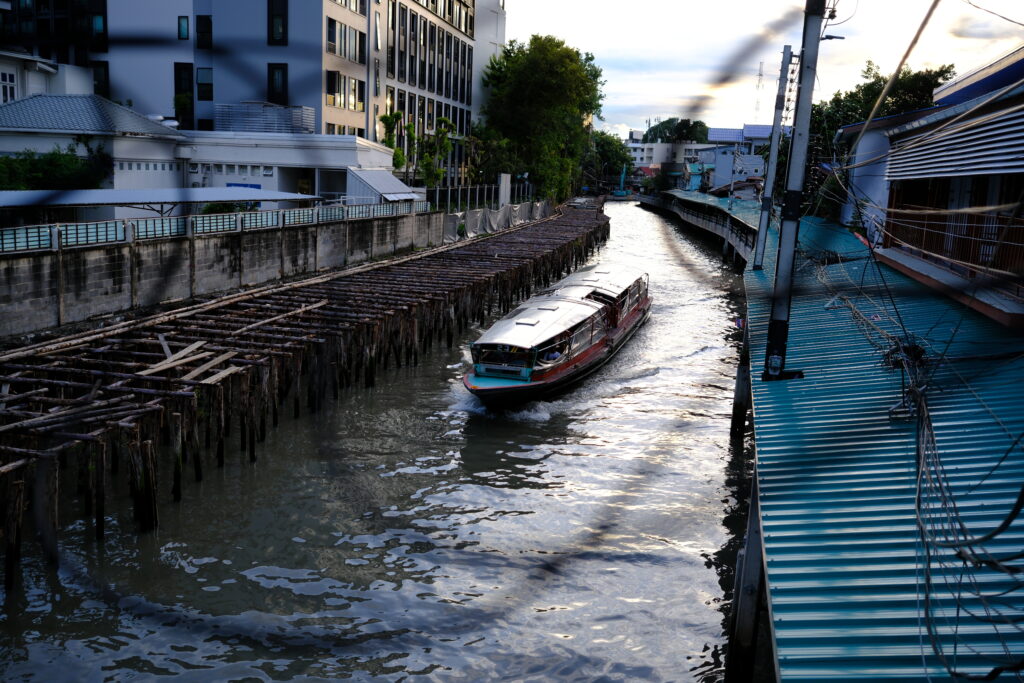 Khlong Saen Saep boat passing the wooden pilings at Ban Khrua