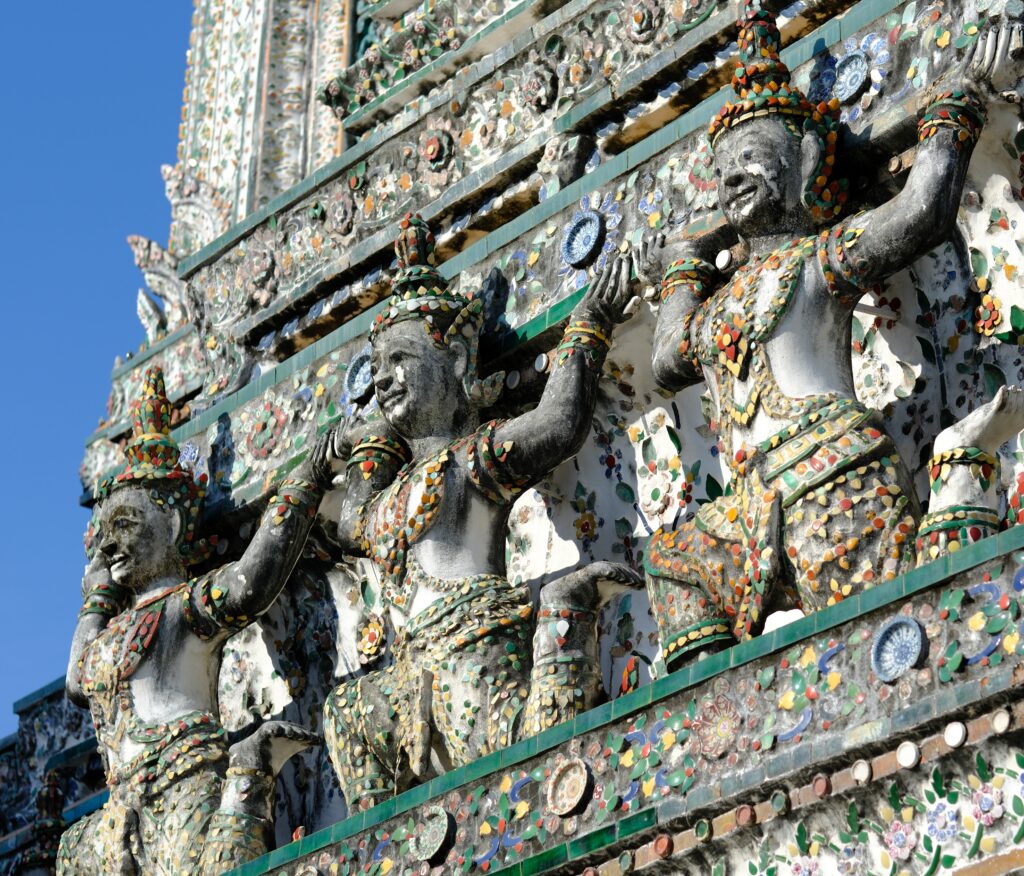 Rows of thewada and yaksha figures in porcelain mosaic supporting the tiers of the Wat Arun prang